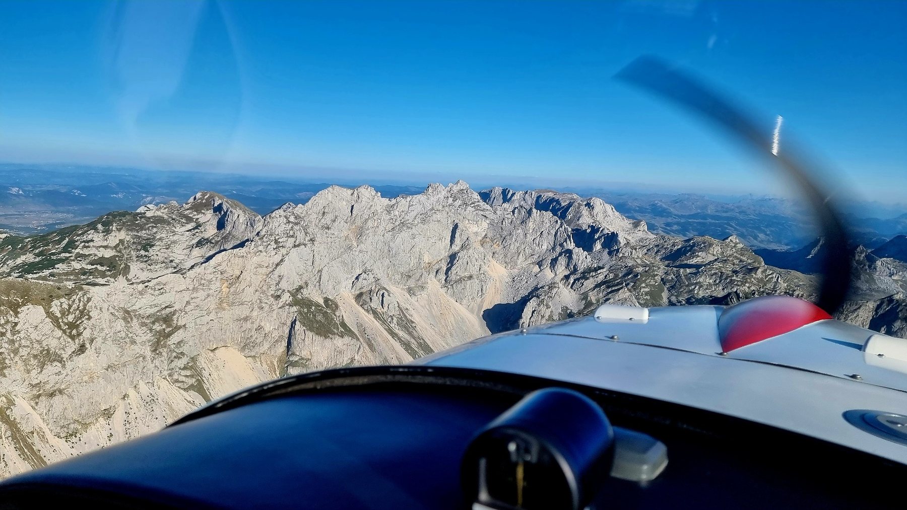 Aeroplane flying over mountain terrain