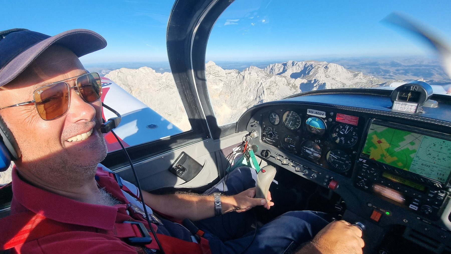Pilot cockpit view over mountains
